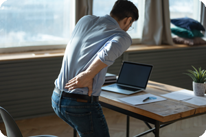 Office worker experiencing sciatica pain in lower back.