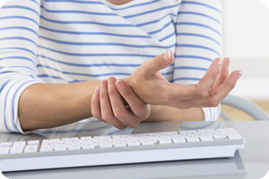 Secretary experiencing carpal tunnel pain from typing.