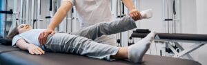 physiotherapist-stretches-childs-foot-and-leg
