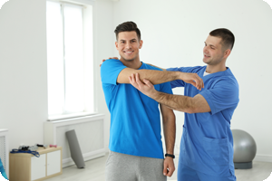 Professional physiotherapist working with male patient.