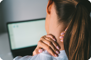 Woman at computer with neck pain.