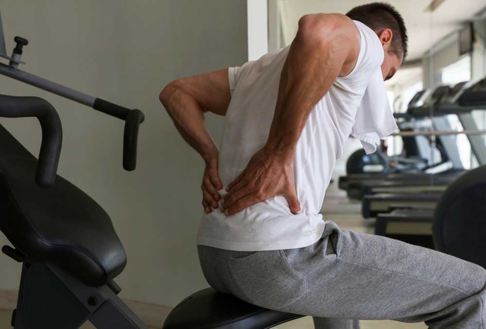 Man with lower back pain while working out.